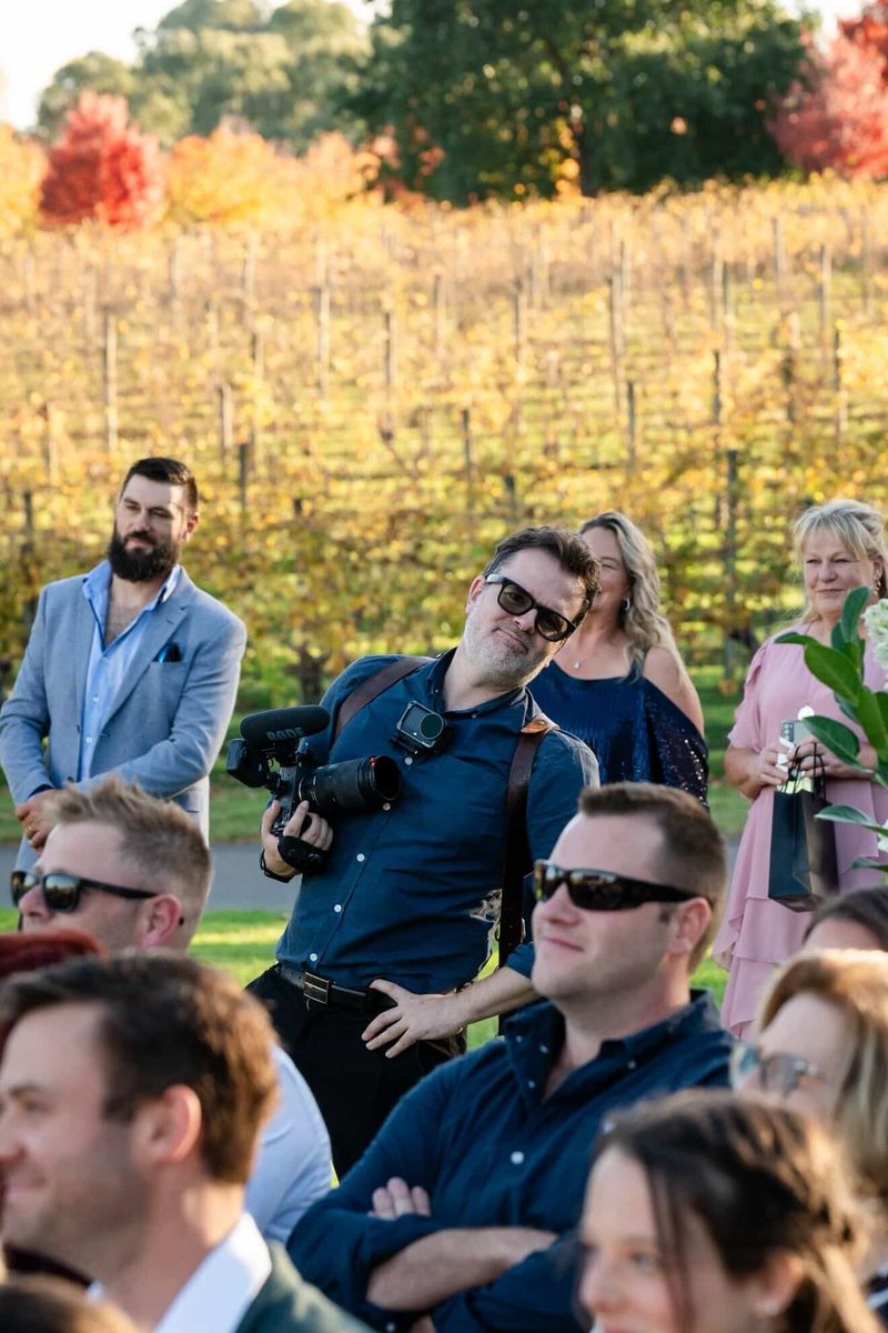 Gareth filming from among the seated ceremony guests